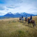 Four pepope enyojing to horse riding in Patagonia, Torres del Paine national park, near the lago Sophia, Puerto Natales. Incredible landscape.