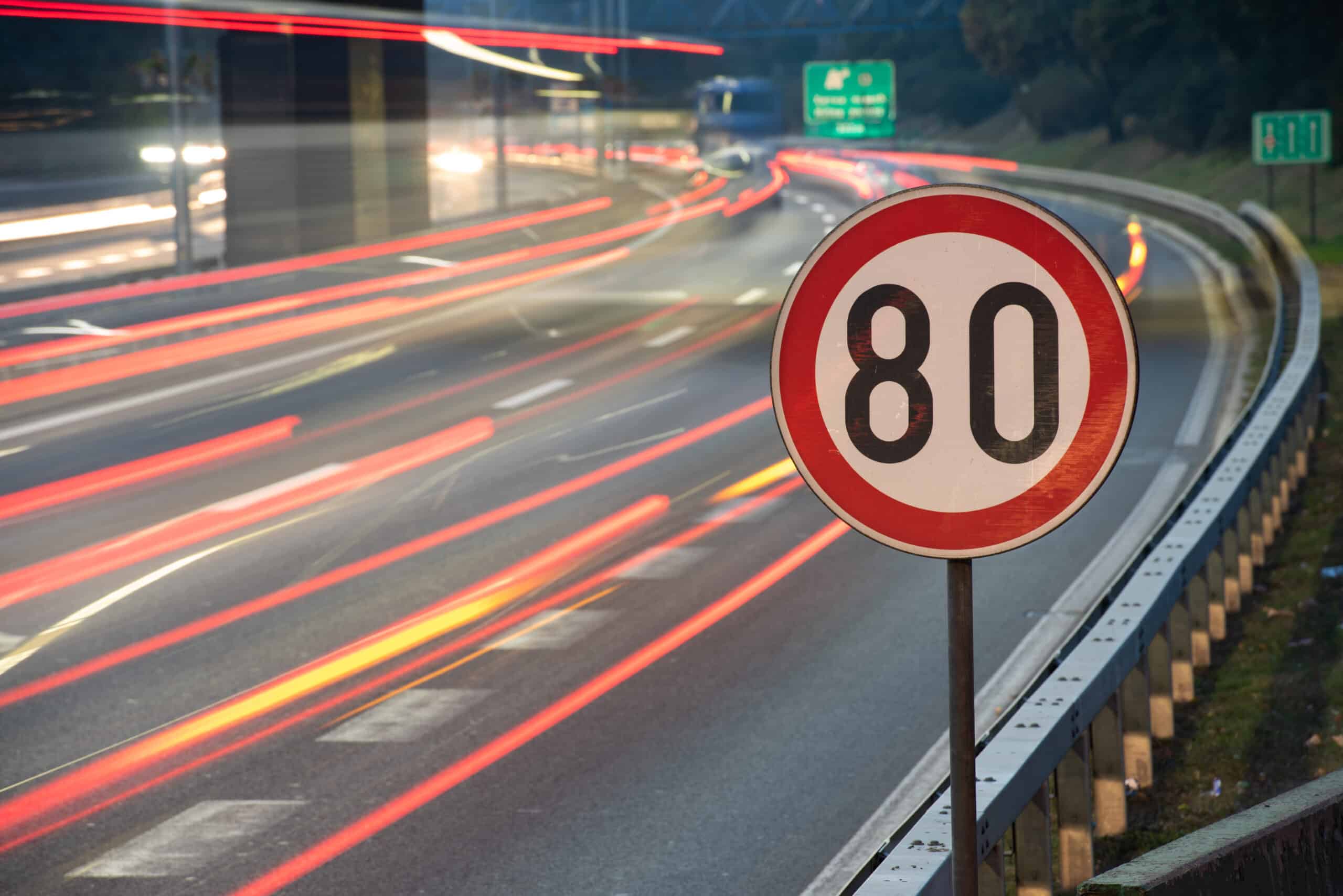 Long exposure shot of traffic sign showing 80 km/h speed limit o ...